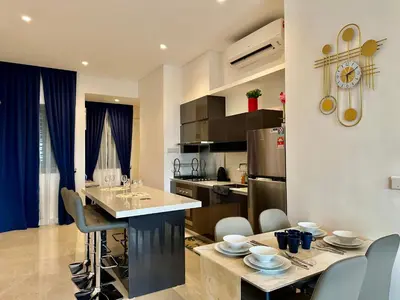 a kitchen and living room with a table and chairs at Luxurious Home Smart service Lucentia residence in Kuala Lumpur