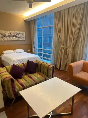 a hotel room with a bed and a couch at KLCC Room in Kuala Lumpur