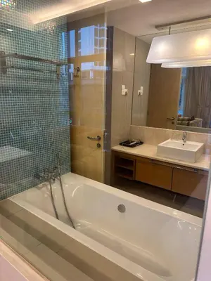 a bathroom with a tub and a sink and a mirror at KLCC Room in Kuala Lumpur