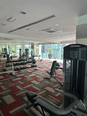 a gym with a lot of cardio equipment in a building at KLCC Room in Kuala Lumpur