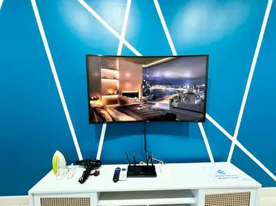 a flat screen tv on a blue wall at ContiNeW Pudu nr Ikea Cheras 2Br-6pax-1park-Wi-fi in Kuala Lumpur