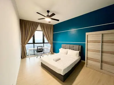 a bedroom with a bed and a blue wall at ContiNeW Pudu nr Ikea Cheras 2Br-6pax-1park-Wi-fi in Kuala Lumpur