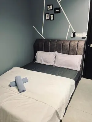 a bed with a blue towel on top of it at Neu suites 001 cozy studio klcc in Kuala Lumpur