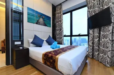 a bedroom with a bed and a large window at The Dorsett Residence Service Suite KL in Kuala Lumpur