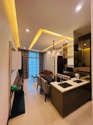 a kitchen and living room with a dining room at The Dorsett Residence Service Suite KL in Kuala Lumpur