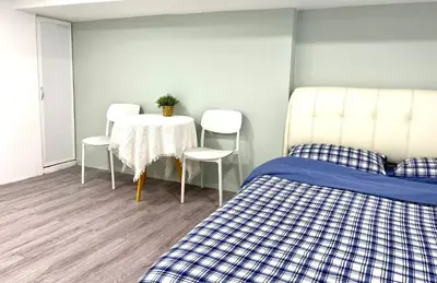a room with two beds and a table and chairs at Cozy home in city center with free parking -1D in Kuala Lumpur