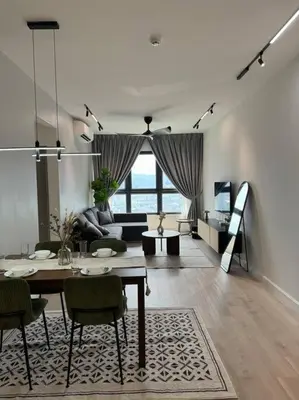 a living room with a table and chairs and a couch at M Vertica Residence in Kuala Lumpur