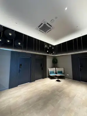 a room with a stage with two chairs and speakers at M Vertica Residence in Kuala Lumpur
