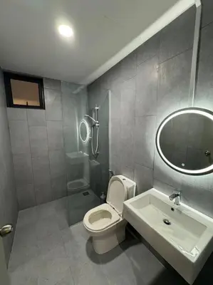 a bathroom with a toilet and a sink and a mirror at M Vertica Residence in Kuala Lumpur