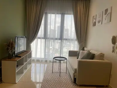 a living room with a couch and a television at CONTINEW Residence - TRX KL in Kuala Lumpur