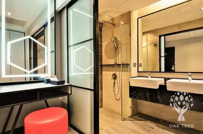 a bathroom with two sinks and a shower at The OAK SUITE AT Menara M101 KL in Kuala Lumpur