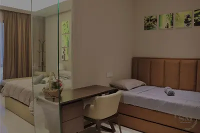 a bedroom with a desk and a bed and a desk and a room with at Dorsett Residences Hartamas in Kuala Lumpur