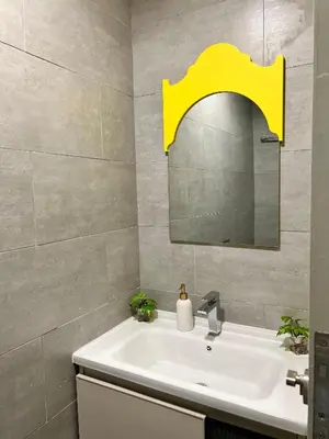 a bathroom with a white sink and a mirror at Arte Mont Kiara By ANQ Suites in Kuala Lumpur