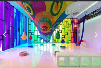 a brightly colored room with a table and a window at Arte Mont Kiara By ANQ Suites in Kuala Lumpur