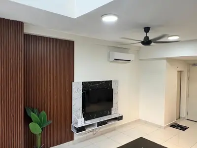 a living room with a television on a wall at Arte Mont Kiara By ANQ Suites in Kuala Lumpur