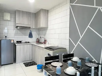 a kitchen with a table with dishes on it at Arte Mont Kiara By ANQ Suites in Kuala Lumpur