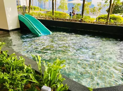 a water slide in a swimming pool at a resort at TRX Continew Residence by Nia in Kuala Lumpur