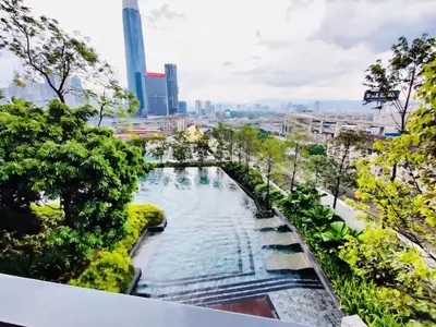 a swimming pool with a city in the background at TRX Continew Residence by Nia in Kuala Lumpur