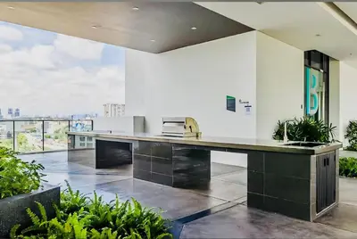 an open kitchen with a large counter and a large window at TRX Continew Residence by Nia in Kuala Lumpur