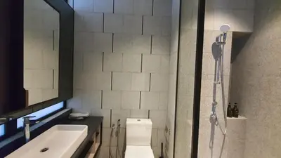 a bathroom with a shower and a toilet and a sink at Klcc Suites at Twin Tower in Kuala Lumpur