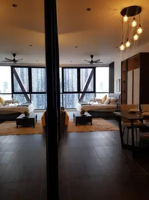 a living room with couches and tables and windows at Klcc Suites at Twin Tower in Kuala Lumpur