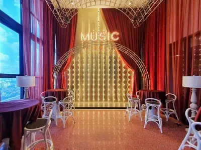a room with chairs and a stage with a mixtape sign at Klcc Suites at Twin Tower in Kuala Lumpur