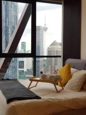 a bed in a room with a large window at Klcc Suites at Twin Tower in Kuala Lumpur