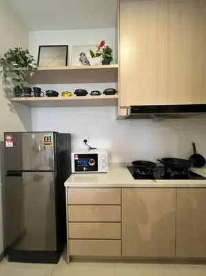 a kitchen with a stove and a refrigerator at The City Edge United Point in Kuala Lumpur