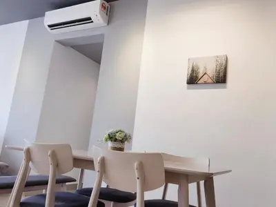 a dining room with a table and two chairs at Luxury 4 Bedroom Suite at Cheras Maluri MRT in Kuala Lumpur