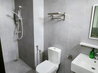 a bathroom with a shower and a toilet and a sink at Luxury 4 Bedroom Suite at Cheras Maluri MRT in Kuala Lumpur