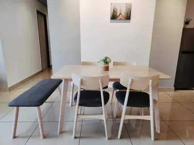 a wooden table with two chairs and a table and a table at Luxury 4 Bedroom Suite at Cheras Maluri MRT in Kuala Lumpur