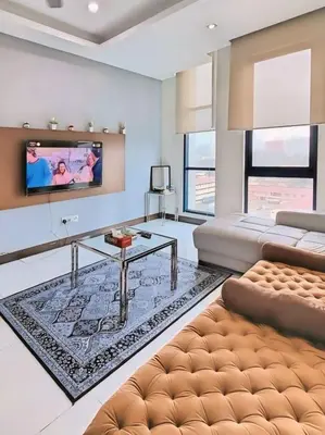 a living room with a couch and a tv at Casa Residency Apartments and suites KL in Kuala Lumpur
