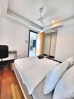 a bedroom with a large white bed and a mirror at Casa Residency Apartments and suites KL in Kuala Lumpur