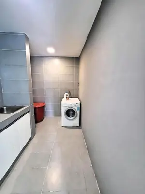 a laundry room with a washing machine in a wall at Casa Residency Apartments and suites KL in Kuala Lumpur