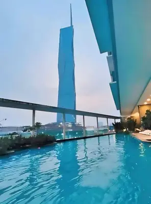 a swimming pool with a view of a tall building at Casa Residency Apartments and suites KL in Kuala Lumpur