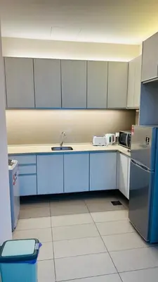 a kitchen with a sink and a refrigerator at SG Residence Kuala Lumpur by Fortune Suites in Kuala Lumpur