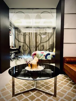 a room with a cake on a glass table at Damas Hotel,Suites and Residence at Plaza Damas 3 by Over The Moon in Kuala Lumpur
