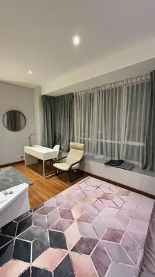 a living room with a pink and purple rug at KLCC Apartment in Kuala Lumpur