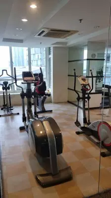 a gym with several tread machines in a room at KLCC Apartment in Kuala Lumpur