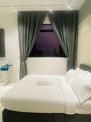 a bedroom with a large bed and a window at Chambers Luxury Suites By Zaff in Kuala Lumpur