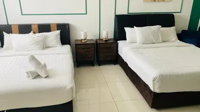 a hotel room with two beds and two night stands at Chambers Luxury Suites By Zaff in Kuala Lumpur