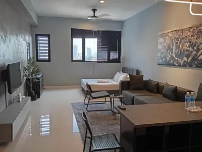 a living room with a couch and a table at Chambers Luxury Suites By Zaff in Kuala Lumpur