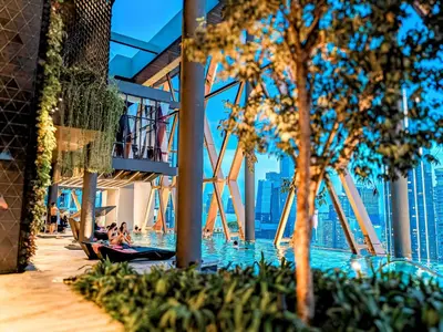 people sitting in chairs in a pool at a hotel at Scarletz Suites KLCC by Luxe Suites in Kuala Lumpur