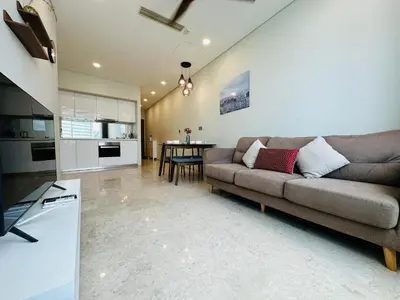 a living room with a couch and a kitchen at Vortex suites KLCC by Nadia Guesthouse Kuala Lumpur in Kuala Lumpur