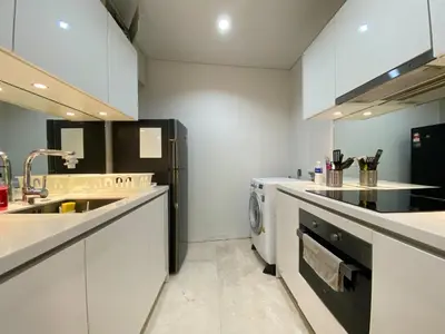 a white kitchen with a sink and a dishwasher at Vortex suites KLCC by Nadia Guesthouse Kuala Lumpur in Kuala Lumpur