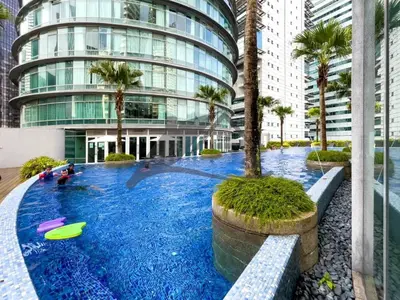 a large swimming pool in front of a building at Vortex suites KLCC by Nadia Guesthouse Kuala Lumpur in Kuala Lumpur