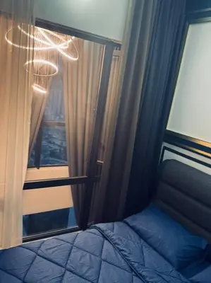 a bedroom with a window with a bed at Blue cozy duplex house in Kuala Lumpur