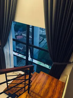 a room with a window with a bench and a curtain at Blue cozy duplex house in Kuala Lumpur