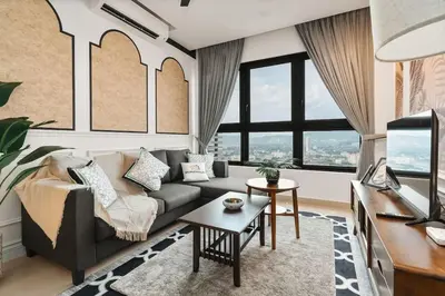 a living room with a couch and a table at IndoChina 3BR MVertica near MRT by RumaBnB in Kuala Lumpur