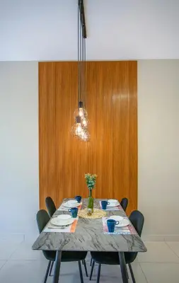 a dining room table with chairs and a light fixture at Trion Residence KL near TRX, MyTown, Ikea Cheras, Pudu in Kuala Lumpur